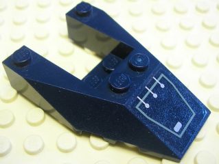 Dark blue LEGO 6x4 cutout wedge brick with stud notches, featuring a silver circuitry pattern sticker, on a light tan baseplate.