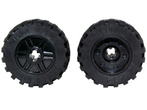 Two black LEGO wheels (part 55982c05 / 92402) with 18mm diameter, axle hole, fake bolts, shallow spokes, and offset tread.