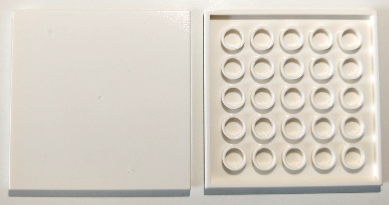 White LEGO 6x6 tile, top surface on left, and bottom with 25 hollow tubes on right.
