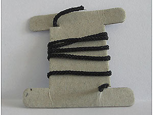 Black medium thickness LEGO string, 30cm, wound on a light gray cardboard spool holder.